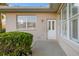 Home exterior showcasing a white door and landscaping at 664 Silk Oak Dr, Venice, FL 34293