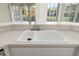 White farmhouse sink with brushed nickel faucet at 664 Silk Oak Dr, Venice, FL 34293