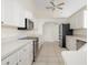 White kitchen with stainless steel appliances and tile flooring at 664 Silk Oak Dr, Venice, FL 34293