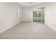 Spacious living area featuring tile floors and sliding glass doors at 664 Silk Oak Dr, Venice, FL 34293