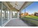 Spacious screened porch with tile flooring and ceiling fan at 664 Silk Oak Dr, Venice, FL 34293