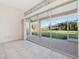 Bright sunroom with sliding glass doors leading to a view of the backyard at 664 Silk Oak Dr, Venice, FL 34293