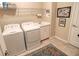 Bright laundry room with washer, dryer, and ample shelving at 11613 Marathon Cir, Venice, FL 34293