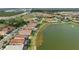 Aerial view of home community with lake and tennis courts at 11684 Renaissance Blvd, Venice, FL 34293