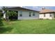 Single-story home with grassy backyard and palm trees at 11684 Renaissance Blvd, Venice, FL 34293