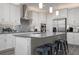 Kitchen island with seating and stainless steel appliances at 11684 Renaissance Blvd, Venice, FL 34293