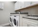 Convenient laundry room with washer, dryer, and cabinets at 11684 Renaissance Blvd, Venice, FL 34293