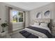 Well-lit bedroom featuring a king-size bed and large window overlooking backyard at 16090 Highgate St, Port Charlotte, FL 33953