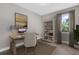 Home office with built-in shelving, desk, and chair, bathed in natural light at 16090 Highgate St, Port Charlotte, FL 33953