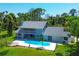 Aerial view of home with pool and lush landscaping at 5885 Denison Dr, Venice, FL 34293