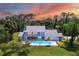 Aerial view of single-Gathering home with pool and private lake at 5885 Denison Dr, Venice, FL 34293