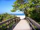 Wooden boardwalk leads to a pristine sandy beach at 5885 Denison Dr, Venice, FL 34293