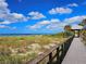 Boardwalk to beach with ocean view at 5885 Denison Dr, Venice, FL 34293