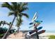Beachfront walkway with palm trees and directional signs at 5885 Denison Dr, Venice, FL 34293