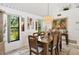 Bright dining room with large windows and elegant chandelier at 5885 Denison Dr, Venice, FL 34293