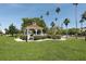 White gazebo with a brown roof in a park-like setting at 5885 Denison Dr, Venice, FL 34293
