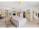 Main bedroom with large bed, walk-in closet, and ensuite bathroom at 5885 Denison Dr, Venice, FL 34293