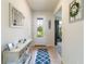 Bright entryway with decorative console table and stylish patterned rug at 13360 Esposito St, Venice, FL 34293