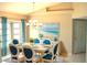 Dining area with coastal-themed art and a table with blue chairs at 5888 Garfield Rd, Venice, FL 34293