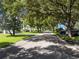 Tree-lined street with single story homes at 1840 Vera Pl # 81, Sarasota, FL 34235