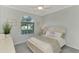 Bedroom with white bed frame and neutral decor at 24774 Bonifay Pl, Venice, FL 34293