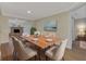 Dining room with wood table and neutral chairs at 1411 Strada D Argento, Venice, FL 34292