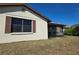 House exterior showcasing a large window and brown shutters at 1411 Strada D Argento, Venice, FL 34292