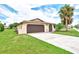 Front view of house with attached garage and driveway at 1411 Strada D Argento, Venice, FL 34292