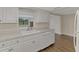 White kitchen with a pass-through window to the living room at 1411 Strada D Argento, Venice, FL 34292