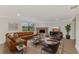 Living room with leather sectional sofa and a brick fireplace at 1411 Strada D Argento, Venice, FL 34292