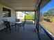 Cozy screened porch with table and chairs, perfect for relaxing at 1411 Strada D Argento, Venice, FL 34292