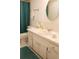 Well-maintained bathroom showcasing vanity storage, a round mirror and neutral decor at 221 Malvern Dr, Venice, FL 34293