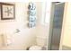 Cozy bathroom featuring a shower, toilet, towel rack and starfish wall decor at 221 Malvern Dr, Venice, FL 34293