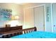 Bedroom showcasing wooden dresser, complemented by a coastal painting and sliding door closet at 221 Malvern Dr, Venice, FL 34293
