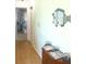 Hallway with wood-look floors and nautical decor at 221 Malvern Dr, Venice, FL 34293