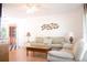 Bright living room featuring wood floors, two sofas, and coastal-themed decor at 221 Malvern Dr, Venice, FL 34293