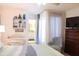 Comfortable bedroom with sitting area, dresser, and ensuite bathroom at 221 Malvern Dr, Venice, FL 34293