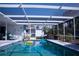 Inviting screened-in pool features a sunny atmosphere, with lounge chairs and a well-maintained outdoor area at 221 Malvern Dr, Venice, FL 34293