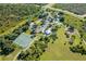 Aerial view of community park with tennis courts, playground, and pavilion at 9 Bunker Ln, Rotonda West, FL 33947