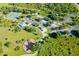 Aerial view of community park with tennis courts, playground, and pavilion at 9 Bunker Ln, Rotonda West, FL 33947