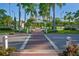 Brick walkway through a community with palm trees at 9 Bunker Ln, Rotonda West, FL 33947