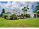 Well-maintained home showcasing lush landscaping and a spacious yard at 9 Bunker Ln, Rotonda West, FL 33947