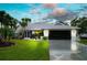 Attractive single-story home with a landscaped lawn and driveway at 9 Bunker Ln, Rotonda West, FL 33947