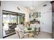 Bright kitchen nook with glass table and wicker chairs, view of pool at 9 Bunker Ln, Rotonda West, FL 33947