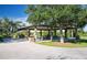 Park pavilion with picnic tables shaded by large oak trees at 9 Bunker Ln, Rotonda West, FL 33947