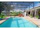 Refreshing pool with screened enclosure, overlooking a tranquil backyard at 9 Bunker Ln, Rotonda West, FL 33947