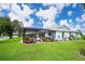 Inviting screened pool with surrounding tropical landscaping at 9 Bunker Ln, Rotonda West, FL 33947