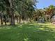 Spacious backyard with mature trees and a large storage shed at 21019 Lawson Ave, Port Charlotte, FL 33952