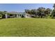 Large backyard with lush green grass and screened porch at 21019 Lawson Ave, Port Charlotte, FL 33952