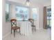 Charming breakfast nook with a round table and two chairs, overlooking the backyard at 21019 Lawson Ave, Port Charlotte, FL 33952